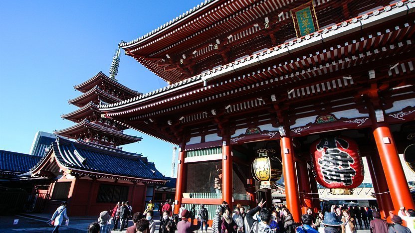 two architectural structures at the temple surrounded by people