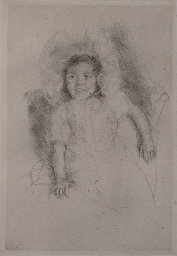 A toddler in a fluffy dress sitting in a chair and looking to her right.