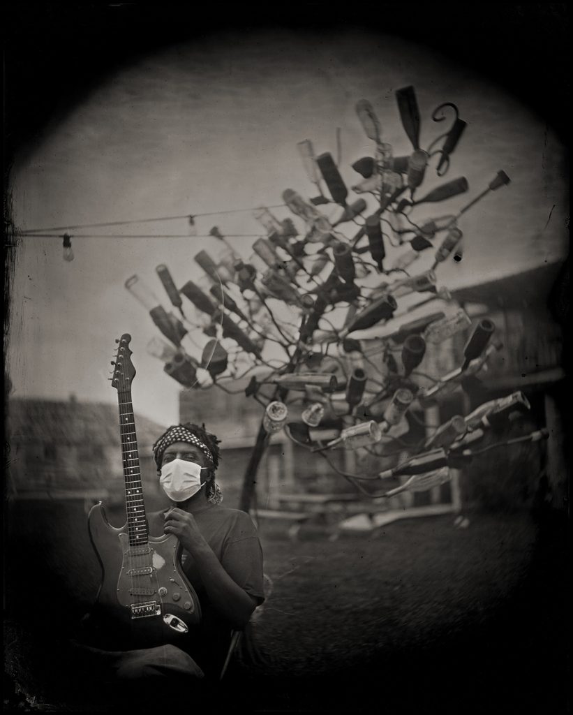 Lucious Spiller and bottle tree, Clarksdale, MS 2020. Bill Steber. Carbon print from wet plate collodion tintype.