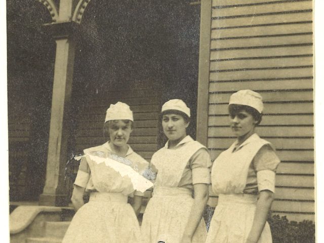 Three 1917 graduates of the Vanderbilt nurse training program posing in front of the nurses’ residence