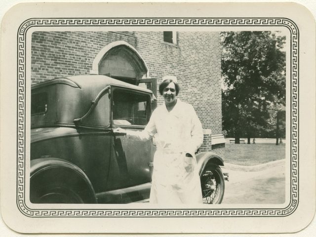 Director of Nursing, Edith Brodie, at the side entrance to what is now Godchaux Hall